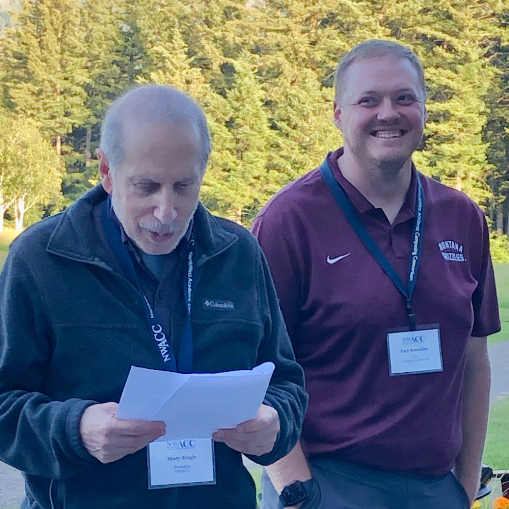 Zach Rossmiller receiving Exemplary Practice Award from Marty Ringle